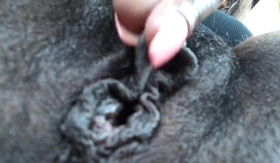 Ebony with pink lipstick masturbates in the car on the parking lot