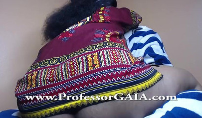 Exotic ebony lifts her dress up & shows her big tits & hairy pussy