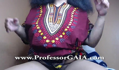 Exotic ebony lifts her dress up & shows her big tits & hairy pussy