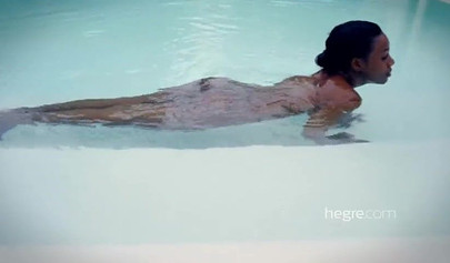 Big boobed Caribbean stunner posing and swimming naked