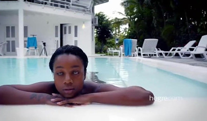 Big boobed Caribbean stunner posing and swimming naked