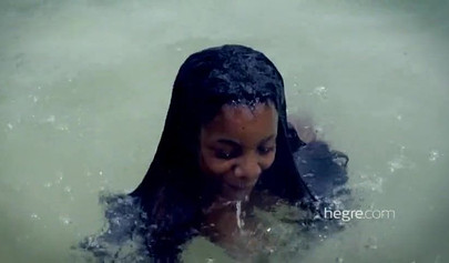 Big boobed Caribbean stunner posing and swimming naked