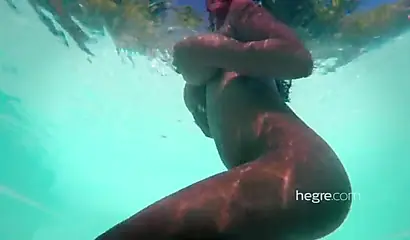 Big boobed Caribbean stunner posing and swimming naked