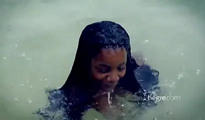 Big boobed Caribbean stunner posing and swimming naked