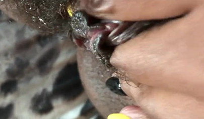 Black slut cums while masturbating up close