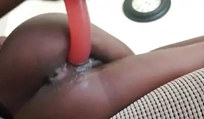 Bored African teen toying her chocolate snatch