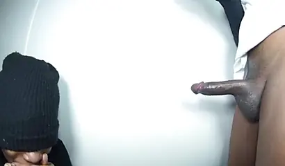 Ebony with a black hat deepthroats a BBC