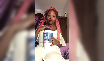 Redheaded ebony with a nose ring screws her black pussy with a white dildo