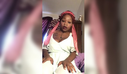 Redheaded ebony with a nose ring screws her black pussy with a white dildo