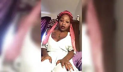 Redheaded ebony with a nose ring screws her black pussy with a white dildo