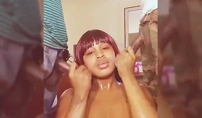 Redheaded ebony slut blows two huge black dicks at once