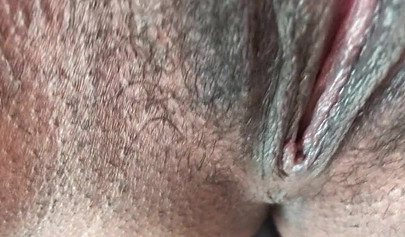 Slutty ebony rubbing her hairy muff up close