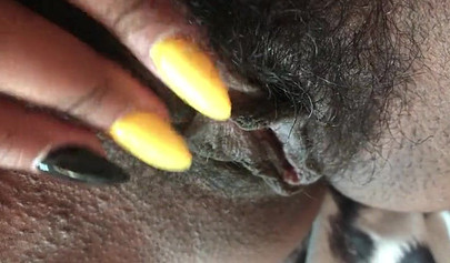 Slutty ebony rubbing her hairy muff up close