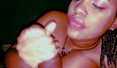 Busty ebony on her side giving a mind-blowing BJ