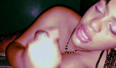 Busty ebony on her side giving a mind-blowing BJ