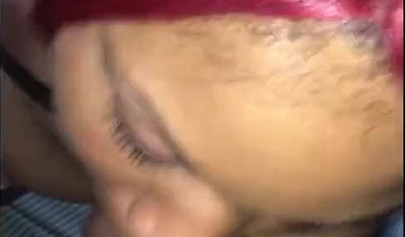 Redheaded ebony slut Caramel Chaun shows off her cock sucking skills