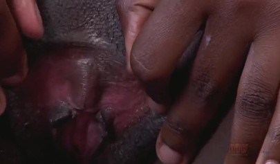 Ebony with glasses shows off her figure while pleasuring herself