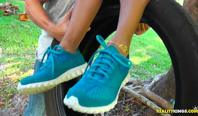 Desirable black chick Kendall Woods gives a blowjob outdoors