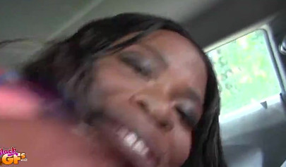 Tiny Ebony gives a blowjob to her man while in the car