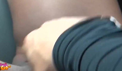 Tiny Ebony with glasses gives a blowjob in a car