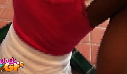 Desirable ebony chick teases with her pretty body in the kitchen