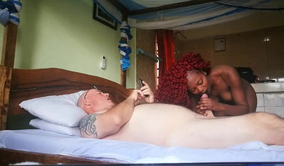 Black babe with gorgeous red curly hair sucks off lazy white gamer guy in his bed