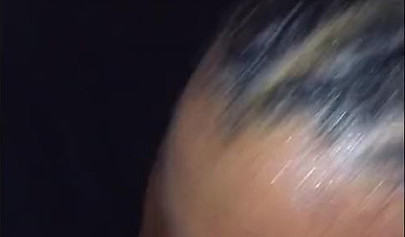 Busty ebony babe sucks cock while lying down on her stomach like a real pro would