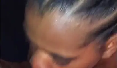 Busty ebony babe sucks cock while lying down on her stomach like a real pro would