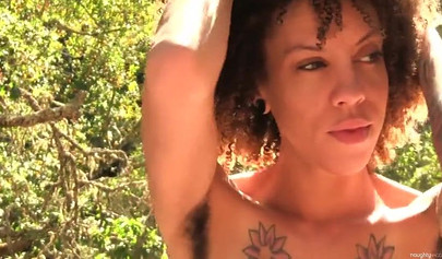 Hairy ebony beauty spreads her legs and rubs up on that pussy in the outdoors