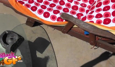 Bikini ebony chick loves catching some rays by the pool side and masturbating too