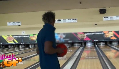Ebony babe goes bowling and is seduced by a white dude to show and flash her tits