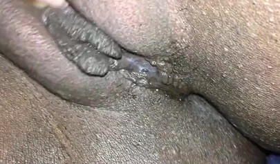 Close up video of a black cock entering a black pussy hard with her legs spread