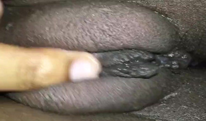 Close up video of a black cock entering a black pussy hard with her legs spread
