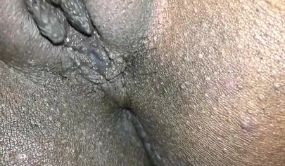 Close up video of a black cock entering a black pussy hard with her legs spread