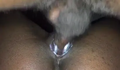 Close up video of a black cock entering a black pussy hard with her legs spread
