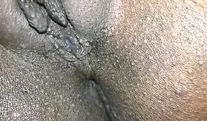 Close up video of a black cock entering a black pussy hard with her legs spread