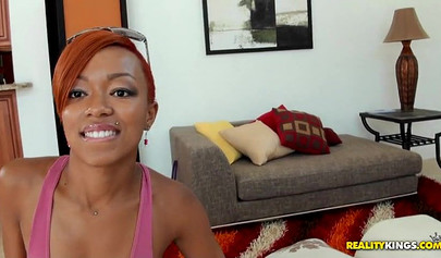 Gorgeous redhead ebony babe strips down naked and sucks on a huge black cock hard