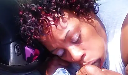 Black woman with curly hair sucks cock in an amateur handheld recording video