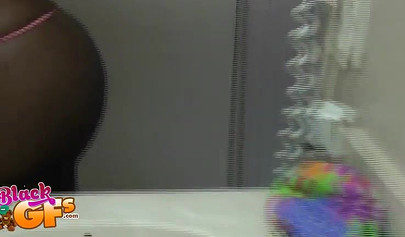 Sexy black amateur babe records herself teasing with her body in front of a mirror