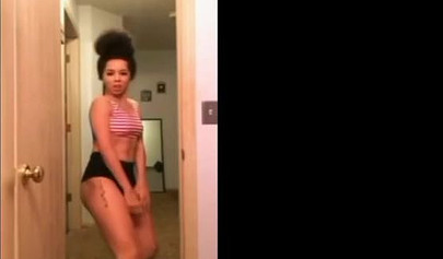 A big booty black girl shakes those phat cheeks and titties for her audience