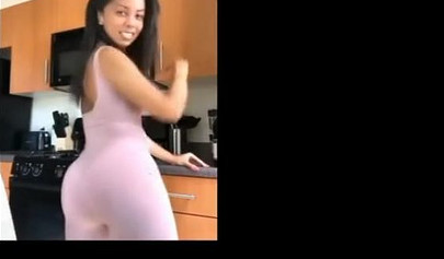 A big booty black girl shakes those phat cheeks and titties for her audience