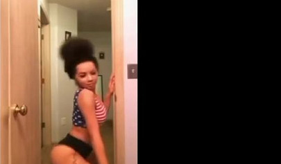 A big booty black girl shakes those phat cheeks and titties for her audience