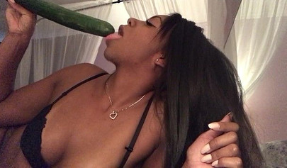 Stunning black chick greases up a pickle and puts it inside her tight wet puss