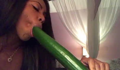 Stunning black chick greases up a pickle and puts it inside her tight wet puss
