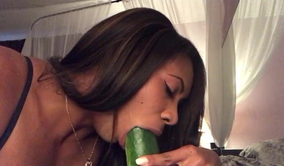 Stunning black chick greases up a pickle and puts it inside her tight wet puss
