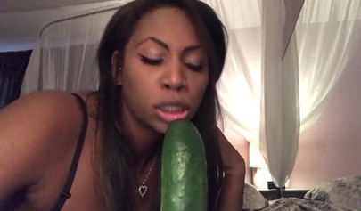 Stunning black chick greases up a pickle and puts it inside her tight wet puss