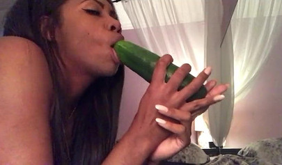 Stunning black chick greases up a pickle and puts it inside her tight wet puss