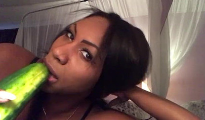 Stunning black chick greases up a pickle and puts it inside her tight wet puss