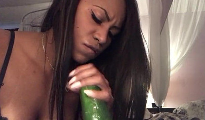 Stunning black chick greases up a pickle and puts it inside her tight wet puss