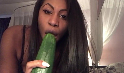 Stunning black chick greases up a pickle and puts it inside her tight wet puss